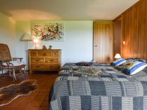 a bedroom with a large bed and a dresser at Hilltop Haven in Parlan in Le Sartre