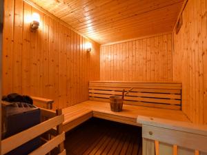 a wooden sauna with a bucket in the middle at Hilltop Haven in Parlan in Le Sartre +32 photos