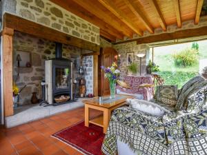 a living room with a couch and a fireplace at Hilltop Haven in Parlan in Le Sartre