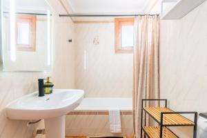a bathroom with a sink and a bath tub at Voramar Alcudia in Alcudia +25 photos