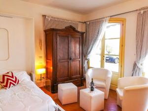 a bedroom with a bed and chairs and a window at Villetta Romantica in Verbania +21 photos