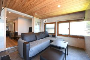 a living room with a couch and a table at BU1 瀬々串 海テラスSesekushi Umi terrace in Kagoshima