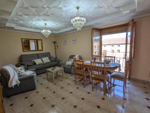 a living room with a table and a couch at Tierra de pinares in Vinuesa