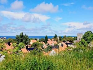 a town with houses and the ocean in the background at 6 person holiday home in VISBY in Visby