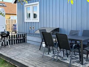 a table and chairs sitting on a wooden deck at 6 person holiday home in VISBY in Visby