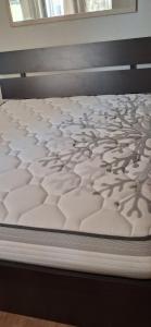 a white mattress on a bed frame in a room at Perla Blu Albania in Durrës