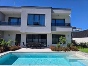 a house with a swimming pool in front of it at Villa Felicity, private pool with heating and salt water in Lozenets