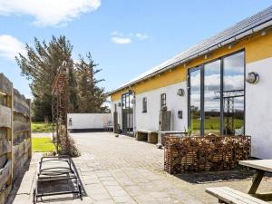 a patio with a building with a ladder next to it at 24 person holiday home in Løkken-By Traum in Grønhøj
