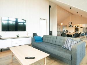 a living room with a couch and a table at 5 star holiday home in Jerup in Jerup