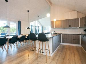 a kitchen with a table and chairs in a room at 5 star holiday home in Jerup in Jerup