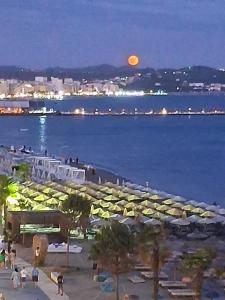 a view of a beach at night with a full moon at Perla Blu Albania in Durrës