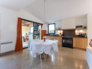 a kitchen with a white table and white chairs at Villa in Malaucène with Mont Ventoux Views in Malaucène