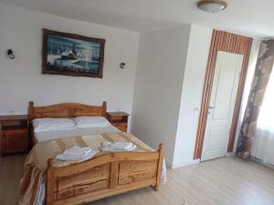 a bedroom with a bed and a picture on the wall at Casa Cornelia in Bran +48 photos