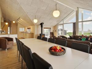 a dining room with a table with a bowl of fruit on it at Luxury Retreat by the Sea - By Traum Ferienwohnungen in Bøjden +23 photos