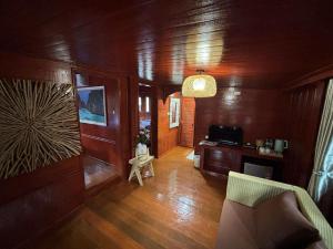 a living room with wood paneled walls and a couch at Guitar Thai Style Pool House in Ao Nang Beach