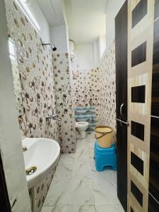 a bathroom with a sink and a toilet at S R Hotel in Varanasi +29 photos