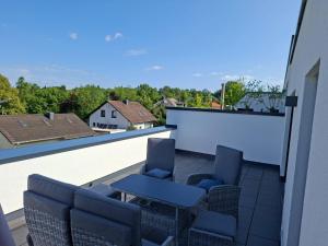 a patio with chairs and a table on a balcony at Ferienwohnung Maria - Bitburg in Stahl