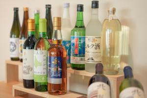 a bunch of bottles of wine sitting on a shelf at Nature Base Hotel NUPPUKOTTE in Teshikaga