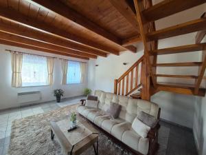 a living room with a couch and a table at Chata HUBERT in Liptovský Ján