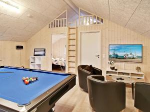 a room with a pool table and some chairs at 5 star holiday home in Kappeln in Kappeln
