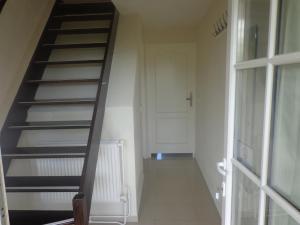 a spiral staircase in a room with a door at Holiday Home in Spijk with Meadow Views in Spijk +14 photos