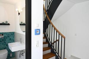 a bathroom with a sink and a staircase at Pidder-Lyng Haus 3 in Böhl +11 photos