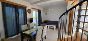a small living room with a table and a couch at Olive Paradise Maison in Kos Town