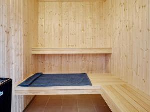 a sauna with a bed in a wooden room at 5 star holiday home in Grenaa in Grenå