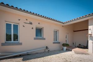 a house with birds on the side of it at Maison Zoé- Haute pyrenees in Saint-Laurent-de-Neste