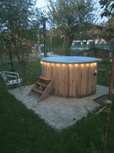 a circular pool with a table and a bench at Casa Cornelia in Bran