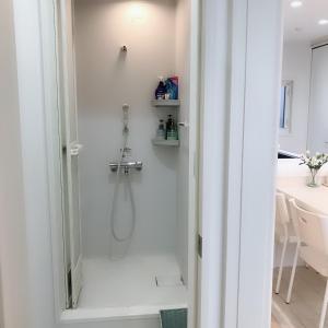 a bathroom with a shower with a glass door at Putao in Osaka