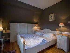 een slaapkamer met een groot wit bed met twee lampen bij Holiday Home in Koksijde near Beach in Koksijde