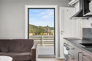 a kitchen with a couch and a large window at Sandefjord 1 bedroom kitchen and bathroom - Non smoking in Sandefjord +8 photos