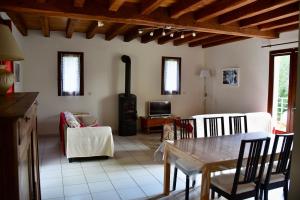 a living room with a table and a stove at Maison de charme à la campagne in Dégagnac +10 photos