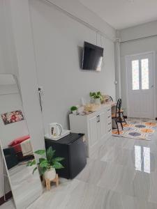 a living room with a kitchen and a dining room at The little home in Bangkok
