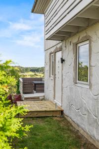 a house with a wooden deck next to a building at Sandefjord 1 bedroom kitchen and bathroom - Non smoking in Sandefjord