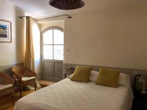 a bedroom with a bed with yellow pillows and a window at Holiday Home in Lacoste with Pool in Lacoste +32 photos
