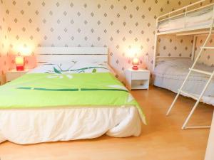 a bedroom with two bunk beds and two lamps at Peaceful Escape in Argeliers in Argeliers
