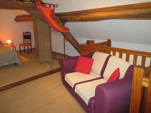 a living room with a couch with red pillows at Holiday Home in Isenay near Lake and Forest in Isenay