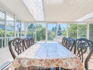 a dining room with a table and chairs and windows at Cozy Airb&b Suite in South Vancouver in Vancouver
