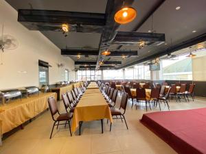 a banquet hall with tables and chairs in a restaurant at LiLLy Hotel DaLat in Da Lat +33 photos