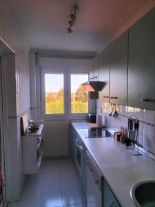a kitchen with a counter and a sink and a window at Salinas en el horizonte in Salinas