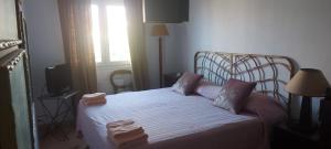 a bedroom with a bed with two towels on it at Salinas en el horizonte in Salinas +1 photo