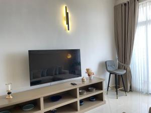 a living room with a couch and a television at Marine Blue Apartment in Dehiwala