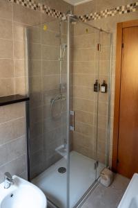 a shower with a glass door in a bathroom at La casa di Anna - Digital Detox in Stolvizza +23 photos