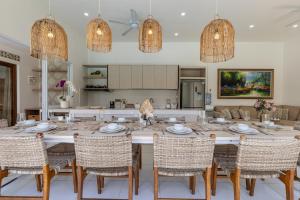 Un comedor con una mesa grande y sillas. en Soma Villa by Betterplace, en Jimbaran