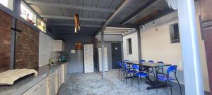 a room with a table and blue chairs in it at Vila Hera in Eforie Sud