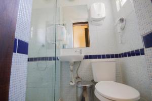 
a bathroom with a toilet and a shower stall at Rio Forest Hostel in Rio de Janeiro
