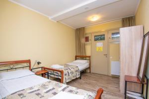 a hotel room with two beds and a door at Express Hotel in Tbilisi City +65 photos