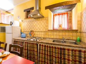 a kitchen with a sink and a refrigerator at Farmhouse in hilly area in Gubbio with pool in Biscina +8 photos